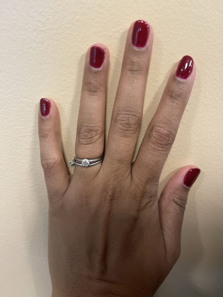 Deep red lacquer manicure.