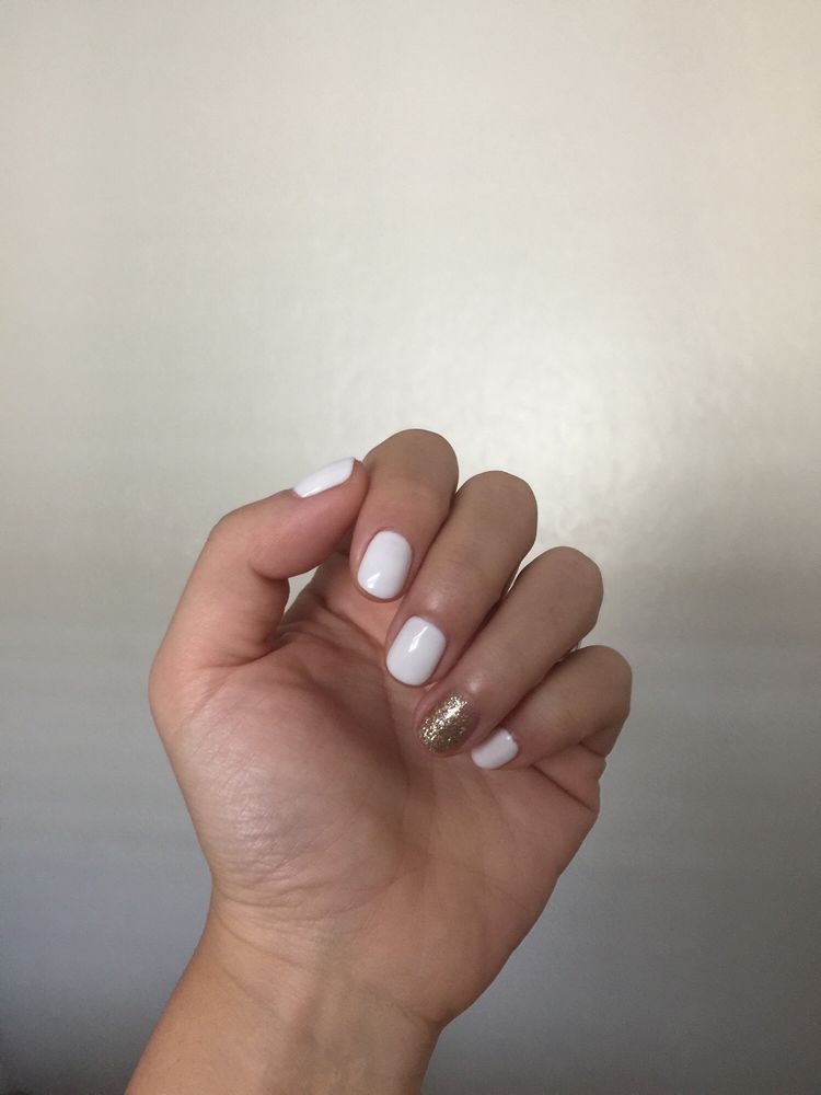 White manicure with a gold glitter accent nail.